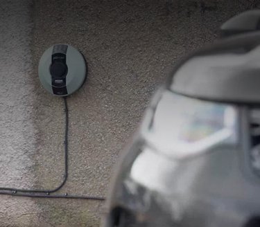 Automotive charging base behind car