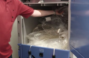 butikspersonal-lägger-plast-i-balpress